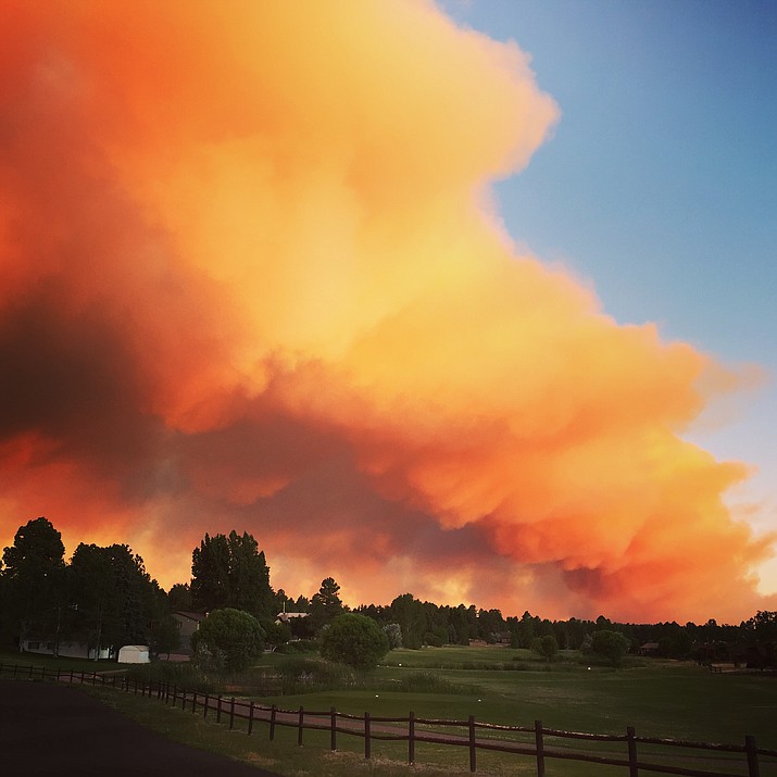 In this photo taken June 15, the day the blaze started, plumes of smoke are visible above a golf course in Show Low. This fire has expanded over the week to cover 26,739 acres and is at 40 percent containment.