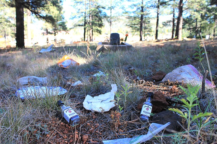 garbage is strewn across several plots at the williams cemetery.