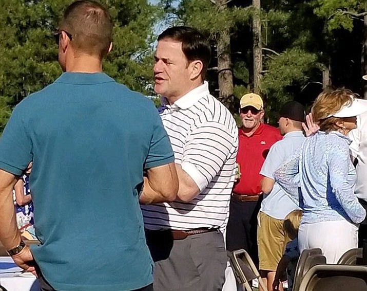 Gov. Doug Ducey attended an Independence Day celebration in Coconino County wearing Nike shoes. (Coconino County Democratic Party/Courtesy)