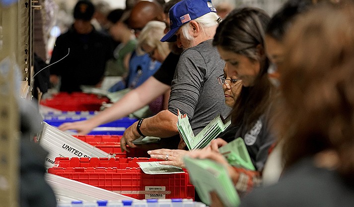 Election workers sort early ballots for signature verification prior to tabulation inside the Maricopa County Recorders Office, Tuesday, Nov. 8, 2022, in Phoenix. (AP Photo/Matt York)