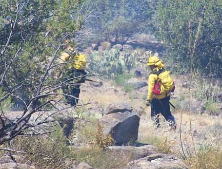 Firefighters work to make sure all hot spots from a wildfire north of Sunset Point on I-17 Saturday are extinguished. The fire, of unknown origin, burned 55 acres and closed the interstate for about three hours Saturday morning. 

Photo courtesy Mayer 
Fire Dept.