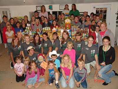 Lonesome Valley 4-H members gather around a huge pile of food goods they collected during their Thanksgiving Food Drive.The 4-H club is also participating in the Adopt a Senior Star Program, which invites the community to participate and send out a small gift to all the Meals on Wheels participants in the Mayer Area. Along with community service, club members have been raising animals, shooting archery, participating in the  “Handwork from our Heritage” and Cake Decorating projects, and the Lonesome Valley 4-H Livestock Judging Team is practicing to go to the Arizona Nationals Competition.