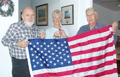 Courtesy Photo<br /><br /><!-- 1upcrlf2 -->Post 122 Finance Officer, Chuck Leon recently awarded Joe and Mary La Valley a Legion thank-you coin in recognition of their efforts in obtaining 50 American flags for The Avenue of Flags supported by Post 122. Joe and Mary are field representatives for Woodmen of the World. The new flags flew at the military monument dedication this past Saturday.