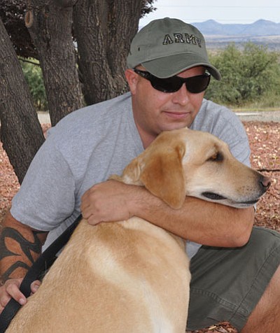 Charlie R. with his retired Army dog Miley.<br>
BBNPhoto/Heidi Dahms Foster