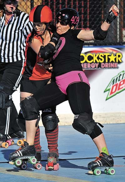 In this file photo, Whiskey Row-ller AfterMath (409) tries to shove Hidden City Bully KemiKill out of bounds in a bout at Pioneer Park in Prescott. The Whiskey Row-llers are having a Day of the Dead themed exhibition bout at 5 p.m. Saturday, Nov. 7. (Matt Hinshaw/The Daily Courier, file)