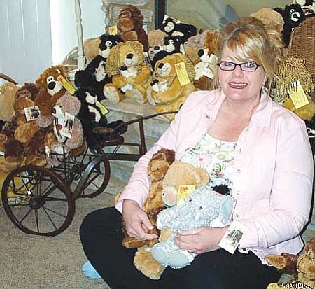 DiAnna sits with all the Bailee Bears that she gives away and sells at the churches she speaks at.