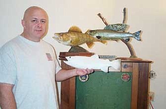 Review/Diane DeHamer<br /><br /><!-- 1upcrlf2 -->Kerby Ross shows a mold of a fish before he starts painting it, and two examples of  finished fish showing his artistic ability.