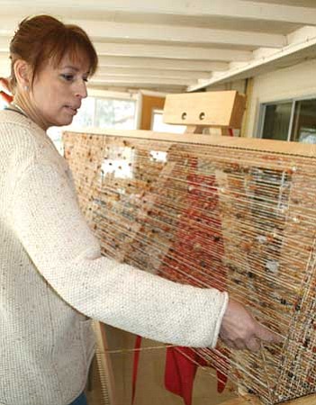 Review<br /><br /><!-- 1upcrlf2 -->Patti Perkins weaves a triangle-shaped shawl on a loom at her home in Chino Valley.