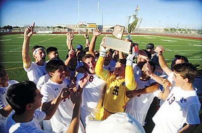 Chino Valley High School’s boys soccer team celebrates its win against Blue Ridge for the AIA Division 5 state championship Saturday. The Cougars had to rally to win, 4-3, to claim their third straight state title and seventh championship overall. Story, Page 10. (Les Stukenberg/PNI)