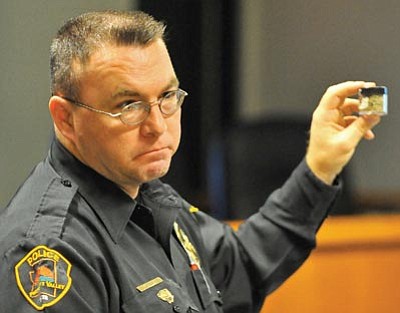Matt Hinshaw/The Daily Courier<br>
Prescott Valley police officer James Tobin holds up a container of the synthetic drug Spice Thursday afternoon during the MATForce Lunch ‘n Learn synthetic drugs presentation at the Yavapai County Administration Building in Prescott.