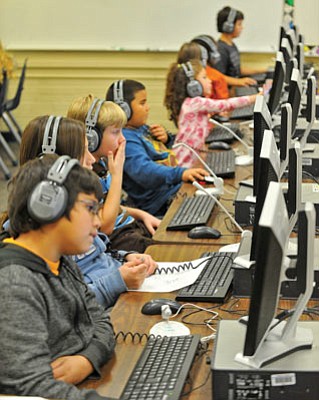 Matt Hinshaw/The Daily Courier<br>Eddie Romero, 11, Ally Romero, 10, Rocco Grecco, 7, and Quinton Flores, 6, students at Miller Valley Elementary School and members of the Kids and Co. after-school program, work on the SuccessMaker computer program to improve their math and grammar skills Thursday afternoon in Prescott.
