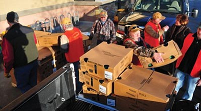 Les Stukenberg/The Daily Courier<br>Members of the Yavapai Yelpers chapter of the National Wild Turkey Federation load up boxes of turkeys, 161 total, that they are donating along with $1,500 to the Yavapai Food Bank to feed less fortunate people a Thanksgiving dinner.
