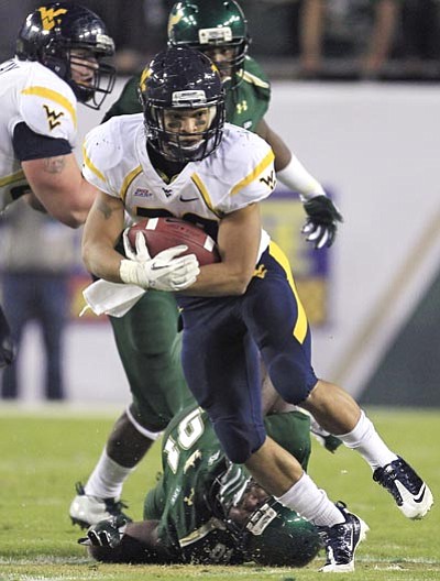 AP Photo/Chris O'Meara<br /><br /><!-- 1upcrlf2 -->West Virginia running back Dustin Garrison (29) cuts past South Florida defensive tackle Keith McCaskill (91) during the first quarter of an NCAA college football game, Thursday in Tampa, Fla.