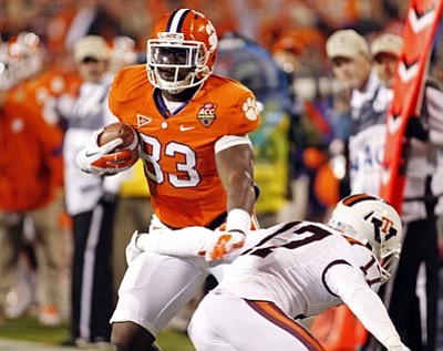 Clemson's Dwayne Allen (83) runs past Virginia Tech's Kyle Fuller (17) for a touchdown during the first half of the Atlantic Coast Conference championship NCAA college football game in Charlotte, N.C., Saturday, Dec. 3, 2011. (AP Photo/Bob Leverone)