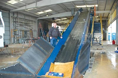 Cheryl Hartz/Courtesy photo<br>Patriot Disposal co-owner Chris Kuknyo points out the final conveyor for waste after recyclable materials from every garbage truckload coming into the business are removed at Patriot’s new recycling center on Valley Road in Prescott Valley.