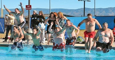 Matt Hinshaw/The Daily Courier<br>Participants in the fifth annual Polar Bear Splash leap into the Mountain Valley Splash Pool in Prescott Valley in 2010. The water temperature at the time of the event was 38 degrees.