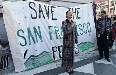 Jeff Chiu/The Associated Press<br>Jeneda Benally, left, and her brother Clayson Benally, both litigants in The Save the Peaks Coalition lawsuit with the U.S. Forest Service, speak outside of the Ninth Circuit Court of Appeals in San Francisco on Monday.