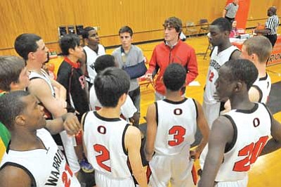 Matt Hinshaw/The Daily Courier<br /><br /><!-- 1upcrlf2 -->The Orme School boys’ basketball team huddles up around first-year coach Grant Hendrikse during a game against Chino Valley Tuesday in Orme.