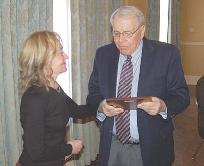 Ken Hedler/The Daily Courier<br>Jan Simmons, left, widow of the late Prescott attorney Jim Simmons, presents the Lifetime Achievement Award to retired judge Raymond Weaver Jr. during a luncheon of the Yavapai County Bar Association this past Wednesday.