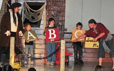Les Stukenberg/The Daily Courier<br>
Members of the Verde Valley Life and Fire Safety group Daniel Elliot and Ben Kramer entertain students from Lincoln Elementary in Prescott Monday. Helping out the firefighters are Lincoln students Taylor Gagnon, Kadon Lee and Eli Gagnon.