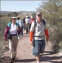 Ted Johnson, right, assistant library director for the Town of Prescott Valley, leads a mixed-age group Jan. 31 on a hike at the Boyce Thompson Arboretum State Park in the Tonto National Forest west of Superior. He led a hike on behalf of the Prescott Valley Parks and Recreation Department.<br /><br /><!-- 1upcrlf2 -->Ken Hedler/The Daily Courier