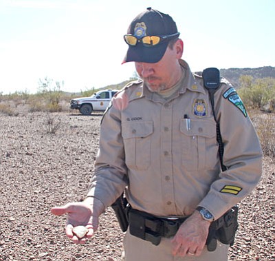 Jason Caffey, BLM/Courtesy photo<br>BLM Ranger Grady Cook holds a piece of ancient pottery at the ancient Hohokam settlement he discovered on the Ironwood Forest National Monument.
