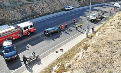 Matt Hinshaw/The Daily Courier<br>Emergency workers begin to clear the scene of a two-vehicle head-on collision on Montezuma Street between Navajo Drive and Granite Creek Park Saturday afternoon in Prescott.  The two drivers that were involved were transported to separate hospitals by air ambulance.
