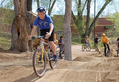 Cindy Barks/The Daily Courier<br>
Local youngsters flocked to the new pump track site at Granite Creek Park Wednesday afternoon to help with the construction and to try out the contours on the track.