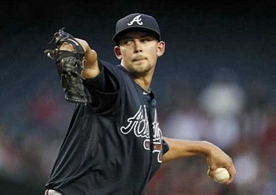 Atlanta Braves' Mike Minor throws against the Arizona Diamondbacks during the first inning in an MLB baseball game on Thursday, April 19, 2012, in Phoenix. (AP Photo/Ross D. Franklin)