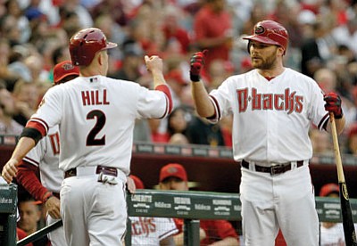 Ross D. Franklin/The Associated Press<br>
Diamondbacks’ Aaron Hill (2) gets a high-five from teammate Jason Kubel after scoring a run against the Philadelphia Phillies during the first inning of Monday’s game in Phoenix.