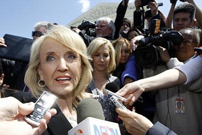 Charles Dharapak/The Associated Press<br>
Gov. Jan Brewer speaks 
to reporters outside the Supreme Court in Washington Wednesday