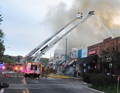 Matt Hinshaw/ The Daily Courier<br>
Firefighters battle a blaze on Whiskey Row in Prescott Tuesday evening.