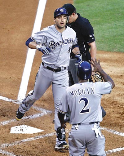 Matt York/AP Photo<br /><br /><!-- 1upcrlf2 -->Milwaukee’s Ryan Braun (8) crosses home plate after hitting a two-run home run Friday in Phoenix.