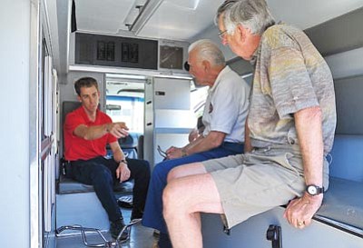 Matt Hinshaw/The Daily Courier<br>
Lifeline Paramedic Matt Mitchell talks with Robert Greninger and Ray Baldwin members of the Sister City Association of Prescott Caborca Committee about the features of the ambulance Lifeline is donating to Prescott’s sister city Caborca, Mexico, Wednesday afternoon in Prescott.