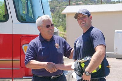 Lisa Irish/The Daily Courier<br>
Prescott Fire Department Chief Dan Fraijo, left, congratulates Prescott Firefighter Dave Haskell upon his graduation Thursday to full-time firefighter status.