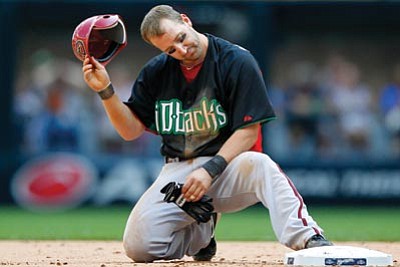 Jeffrey Phelps/The Associated Press<br>
The Diamondbacks’ Willie Bloomquist reacts after getting thrown out trying to steal second base in Sunday’s game against the Brewers in Milwaukee.
