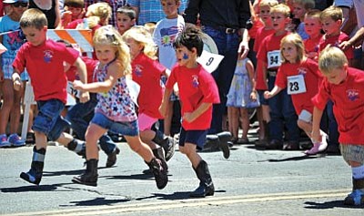 Matt Hinshaw/The Daily Courier<br>
Kids in the 4- to 5-year-old category take off down Whiskey Row during the annual Whiskey Row Boot race Saturday morning in downtown Prescott.
 

