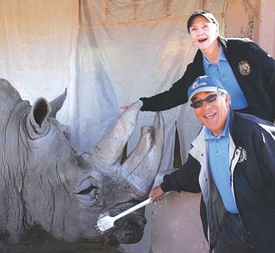 Out of Africa/Courtesy photo<br>
Boom Boom gets a fly wash from Al Raitano, with his wife Sydney, employees at Out of Africa Wildlife Park, where Al shared a special bond with the rhino.