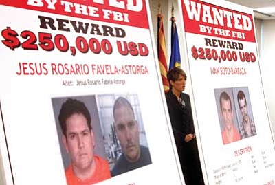 Ross D. Franklin/The Associated Press<br>
Laura E. Duffy, U.S. Attorney for the Southern District of California, is flanked by wanted posters as she speaks at a news briefing where she announces the indictment of five suspects Monday, related to the death of U.S. Border Patrol agent Brian Terry.