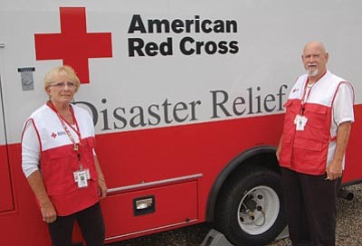 Ken Hedler/The Daily Courier<br>
Marlene and Bob Haynes of Prescott stand in front of an American Red Cross emergency response vehicle that they drove to Colorado Springs, Colo., to aid victims of the Waldo Canyon Fire, the worst wildfire in Colorado history.