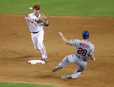 XXXX/The Associated Press<br /><br /><!-- 1upcrlf2 -->New York’s Daniel Murphy (28) is forced out by Arizona’s Aaron Hill as Hill unsucessfully tries to turn a double play on Jason Bay during the eighth inning Friday in Phoenix.