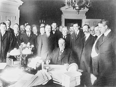 Sharlot Hall Museum/Courtesy photo<br>President William Howard Taft signs the Arizona Statehood Proclamation on Feb. 14, 1912, with Ralph Cameron standing in the foreground at Taft’s right shoulder.