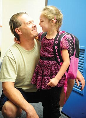 Les Stukenberg/The Daily Courier<br>
Kyal Marshall shares a moment with his daughter Kyra, an incoming kindergarten student, as students at Washington Traditional School begin the 2012-13 school year Monday in Prescott. Marshall said he was nervous watching his little girl head off to school for the first time.
Les Stukenberg/The Daily Courier