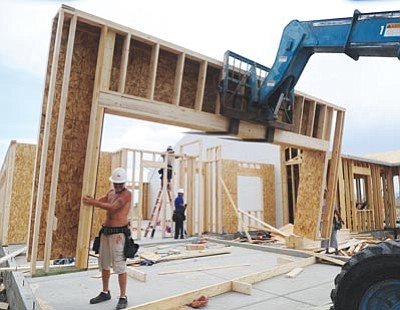 Les Stukenberg/The Daily Courier<br>Framers from UCG set up the garage entrance at a new home on Savoy Place in the Granville subdivision on Wednesday morning.