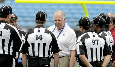 Mike McCarn/The Associated Press<br>Officiating Observer Ron Baynes talks with officials prior to this past Friday night's game between the Panthers and Dolphins in Charlotte, N.C.