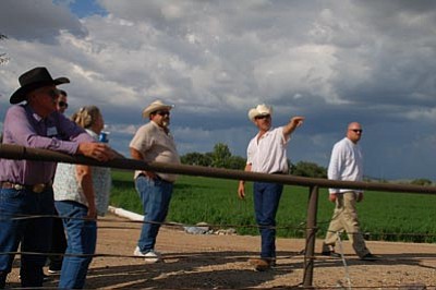 Cindy Barks/The Daily Courier<br>
Jerry Esparza of Chino Farms, second from right, explains the company’s alfalfa-production operation to local officials and candidates who participated in a Friday afternoon Yavapai County Farm Bureau tour of agricultural businesses in the Chino Valley area.
