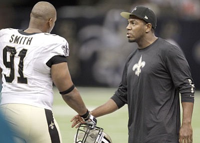Matthew Hinton/The Associated Press<br>New Orleans Saints defensive end Will Smith (91) and New Orleans Saints linebacker Jonathan Vilma talk in the second half this past Sunday in the Superdome.

