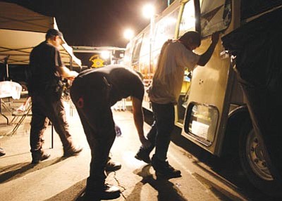 Ross D. Franklin/The Associated Press, file<br>
Maricopa County Sheriff’s deputies pat down a suspect arrested during a crime suppression sweep in Phoenix July 29, 2010.