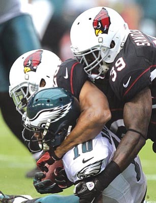 Paul Connors/The Associated Press<br>
Philadelphia Eagles wide receiver DeSean Jackson, left, is tackled shy of the end zone by Arizona Cardinals safeties Kerry Rhodes, center, and James Sanders, right, to prevent a touchdown in the second quarter of Sunday’s game in Glendale.