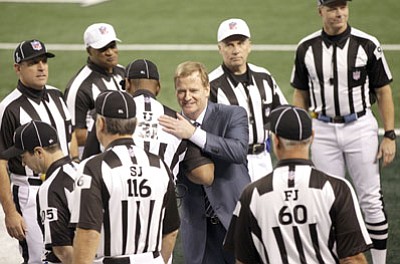 Marcio Jose Sanchez/The Associated Press<br>In this Feb. 6, 2011 file photo, NFL commissioner Roger Goodell greets game officials before Super Bowl XLV in Arlington, Texas. The NFL's regular officiating crews are back. Their return couldn't have come soon enough for many players, coaches and fans.